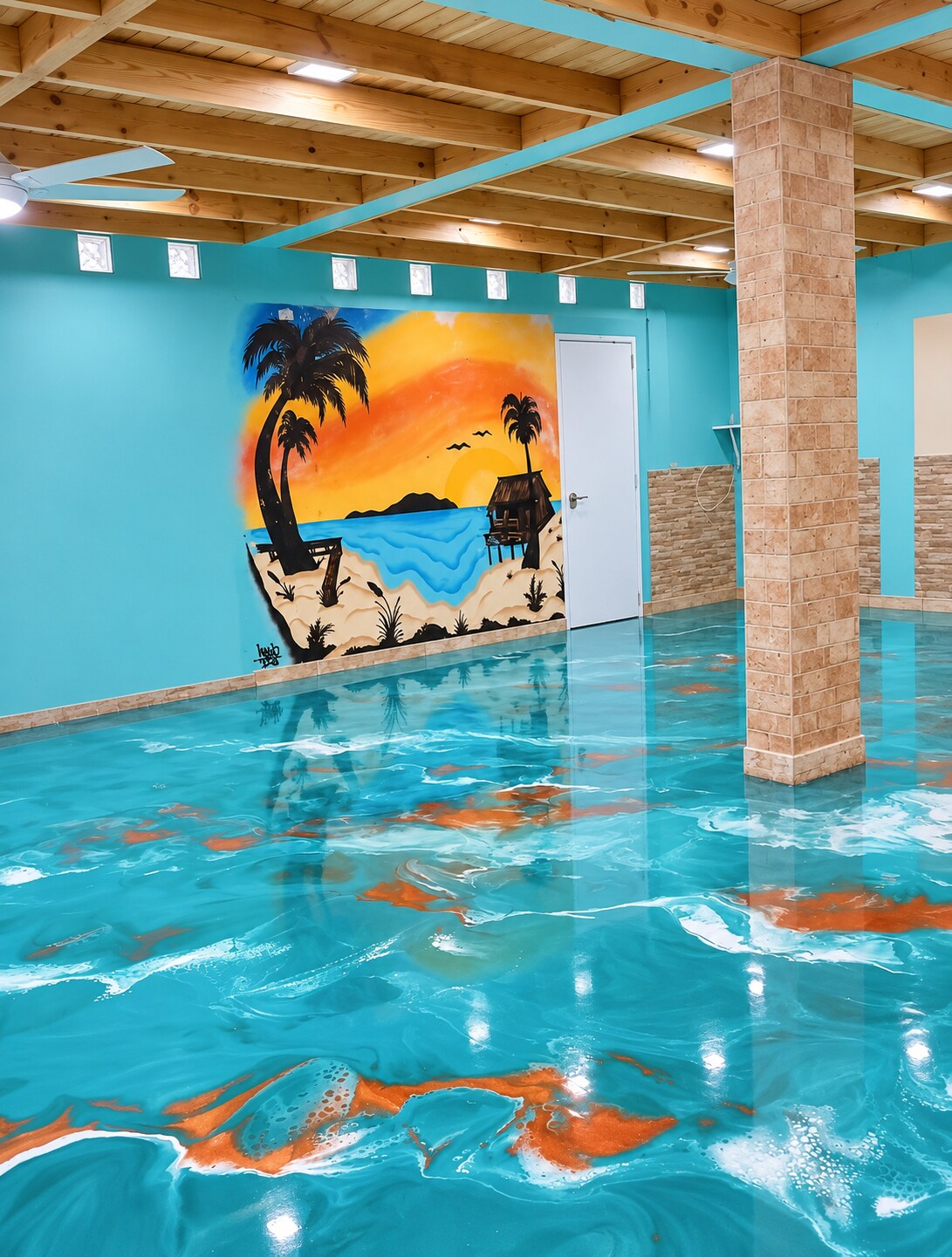 Completed turquoise metallic epoxy floor beside a tropical wall mural
