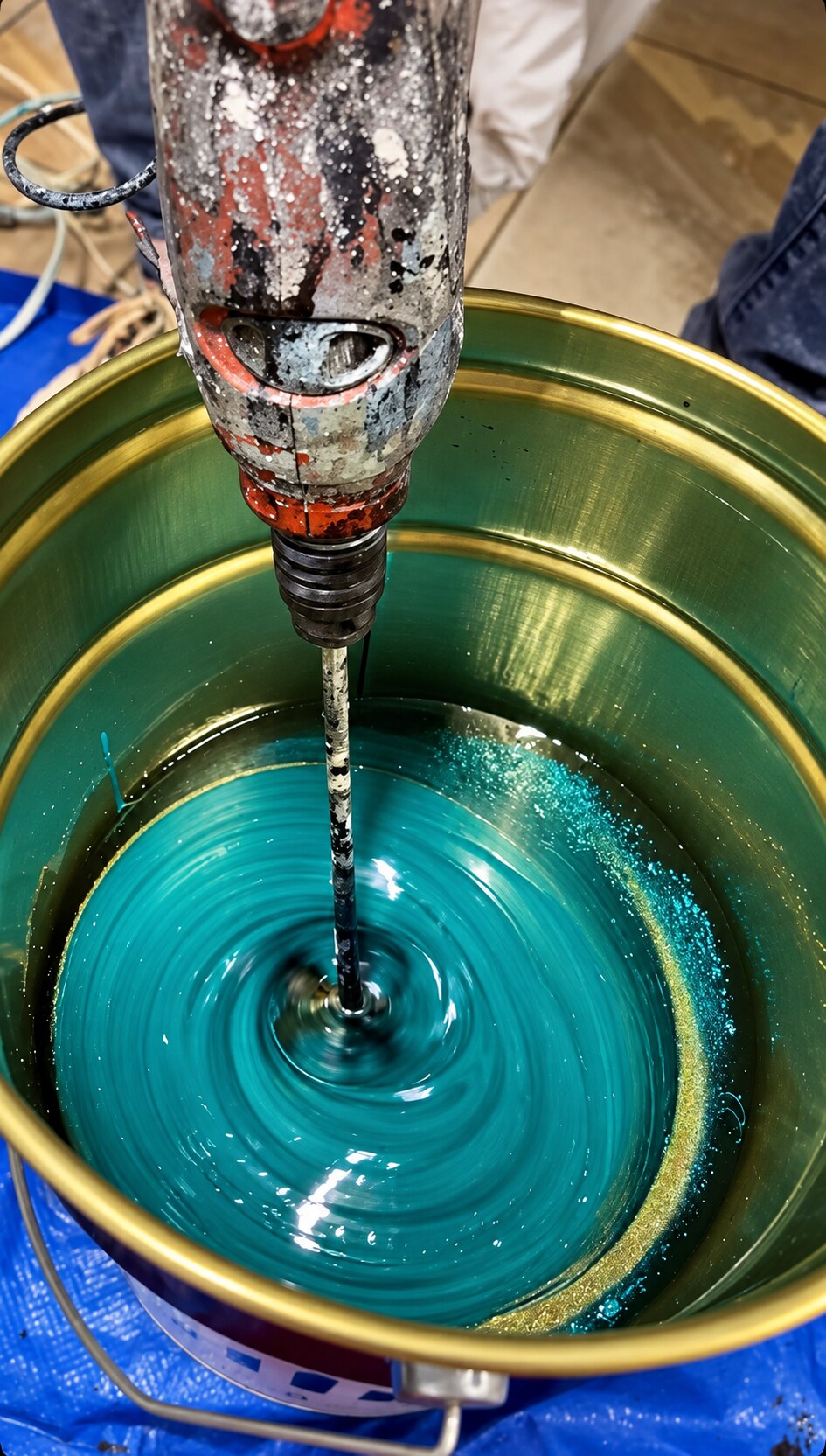 Turquoise metallic epoxy being mixed for installation